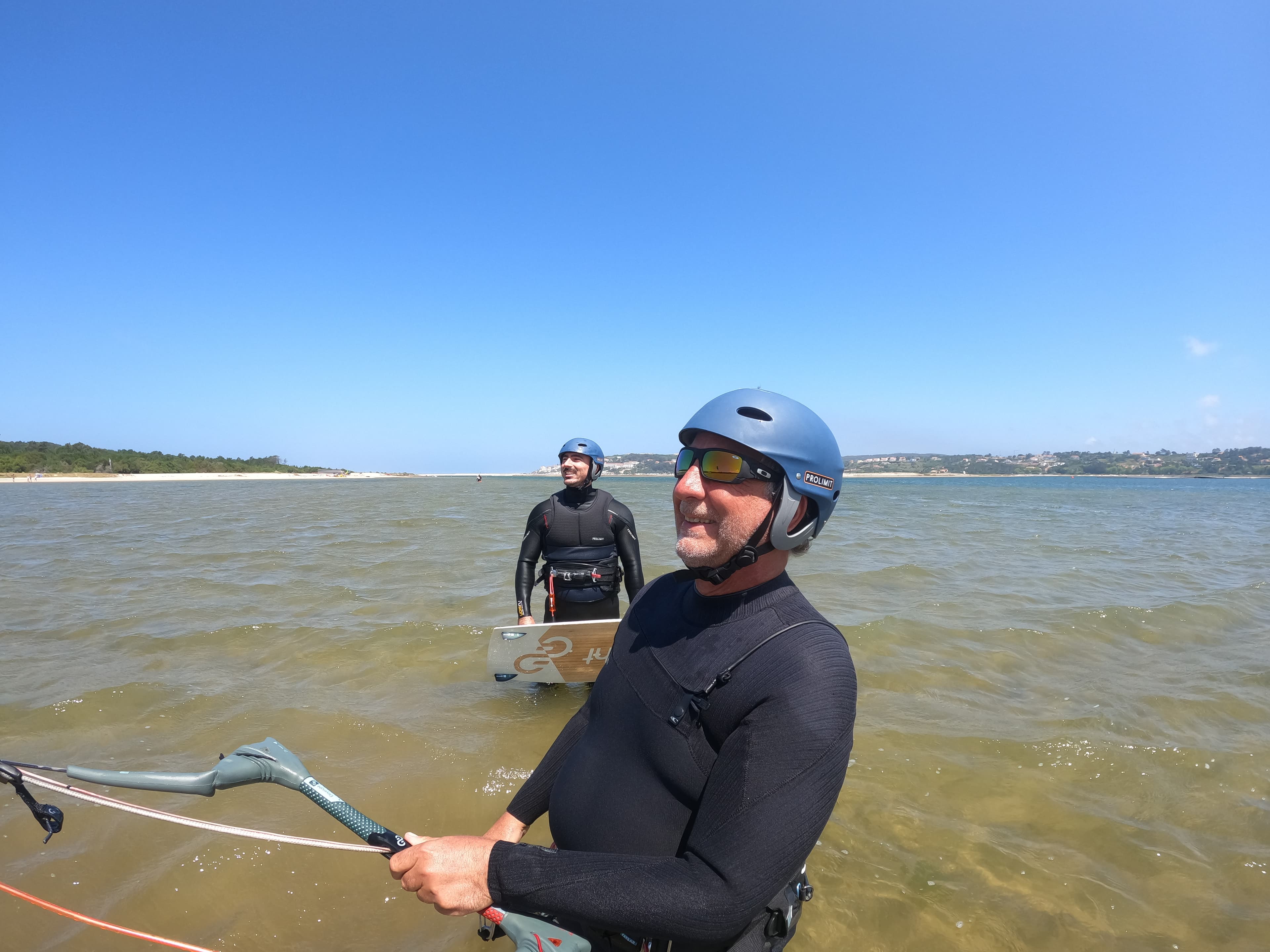 Peter coaching two students in the shallow lagoon water
