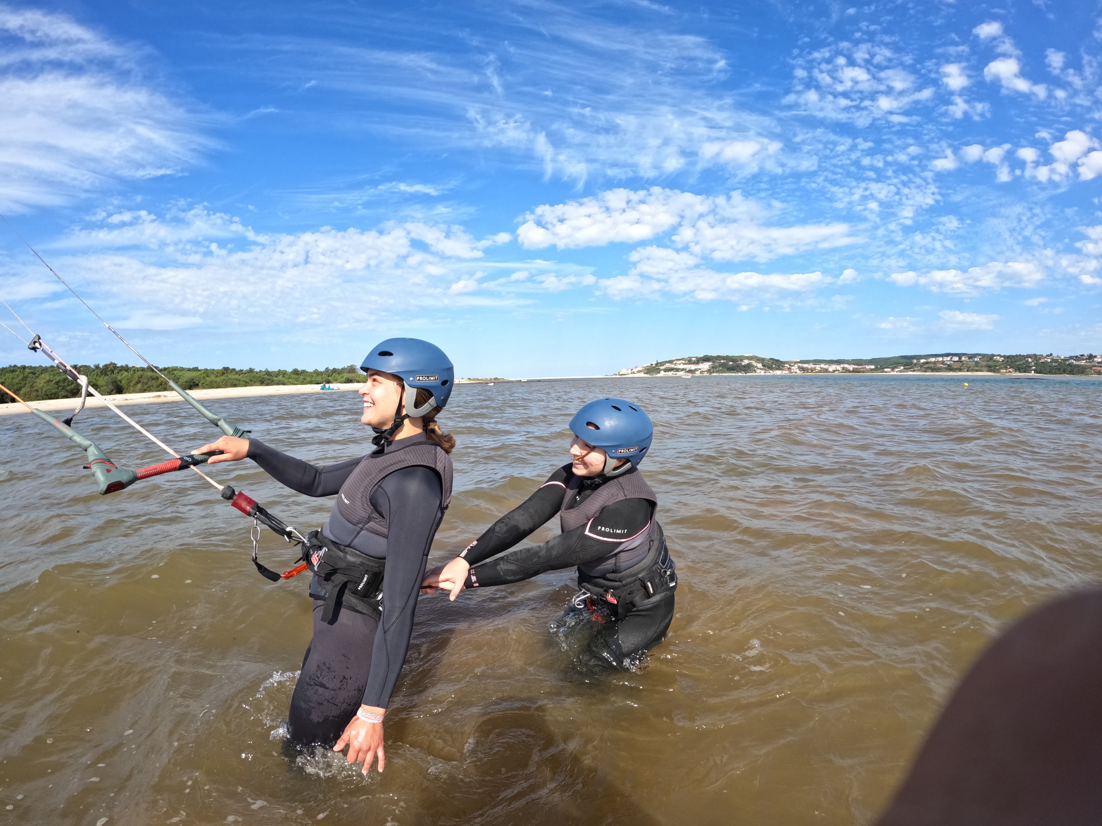 Peter coaching two students in the shallow lagoon water