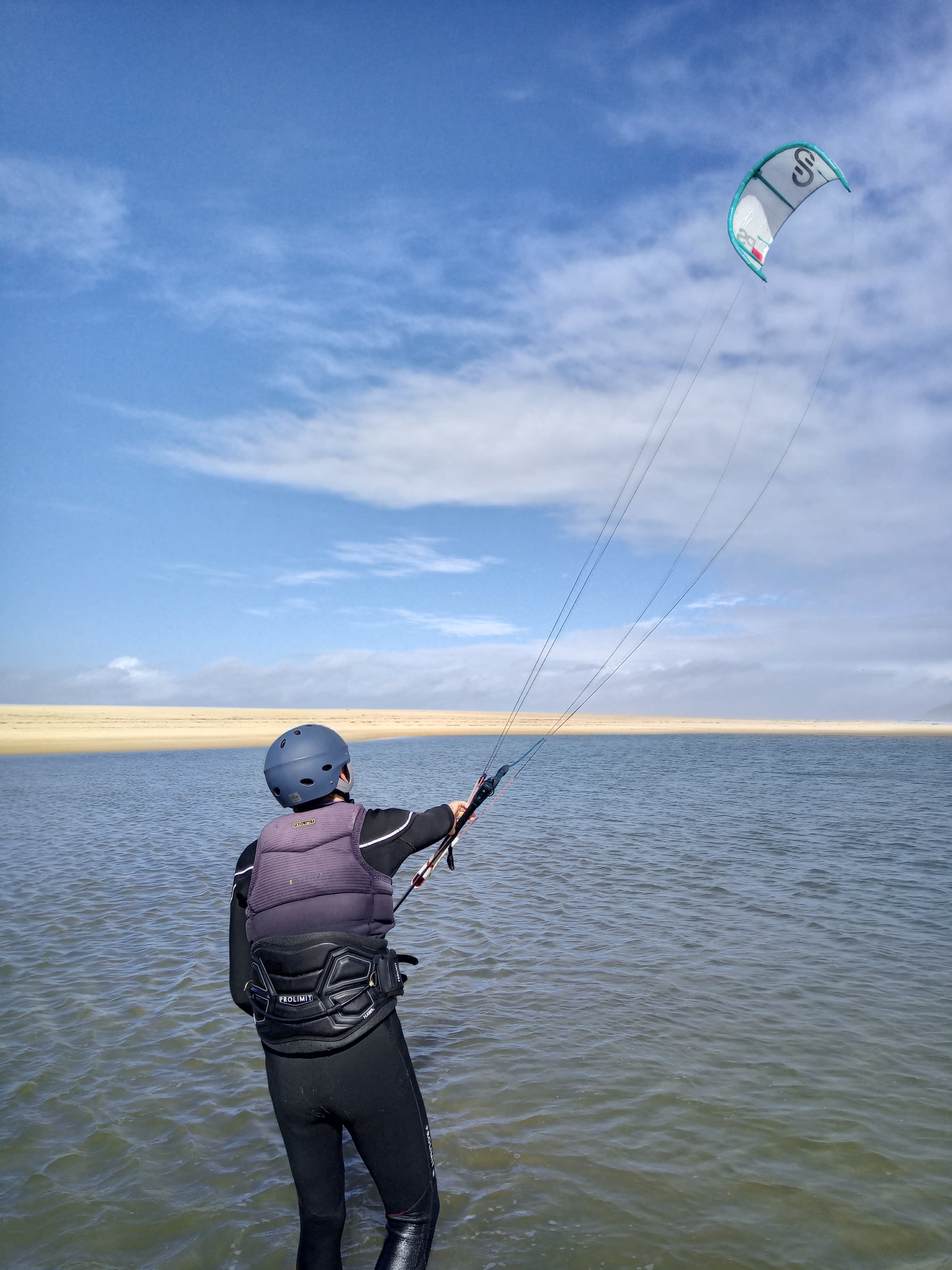 Student practicing kite control in shallow water