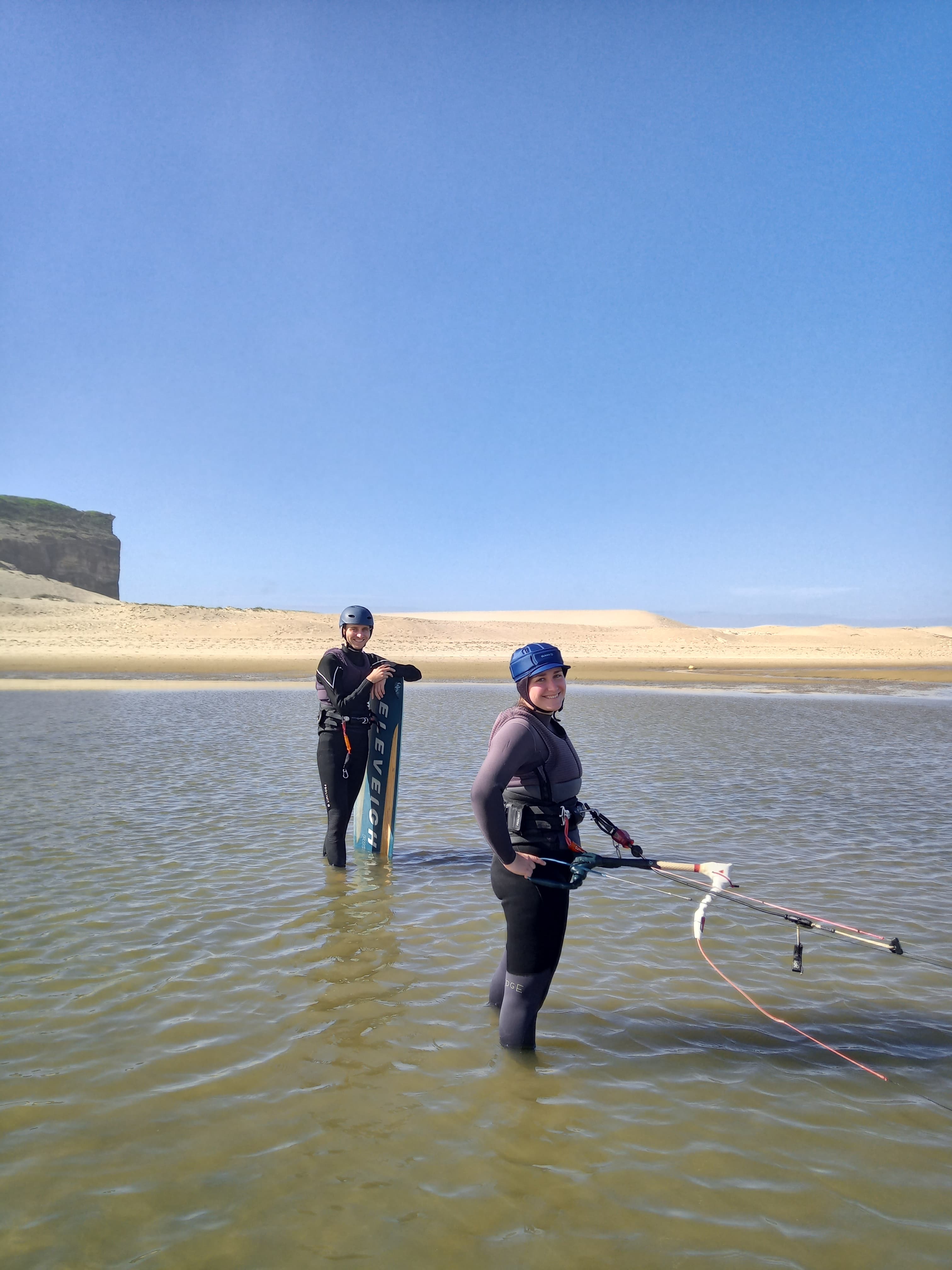 Two students learning kite control in the lagoon